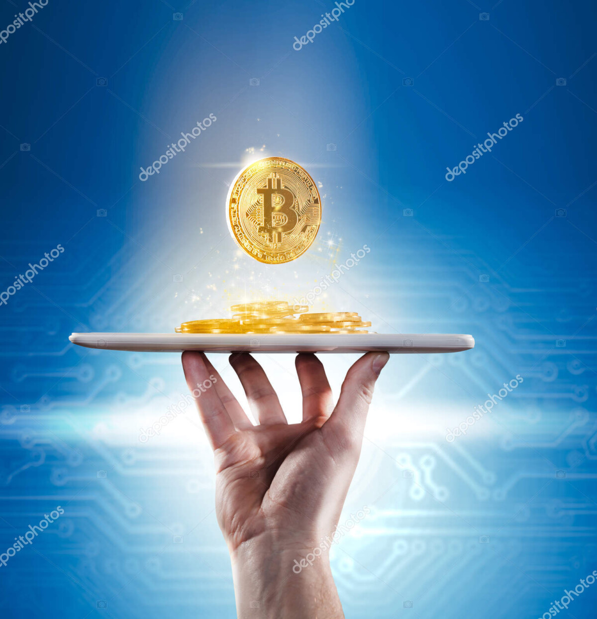 hand holding mobile tablet with stack of bitcoin coins against t