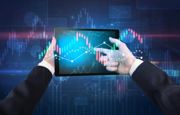 Hand holding tablet with global reports and stock market change concept